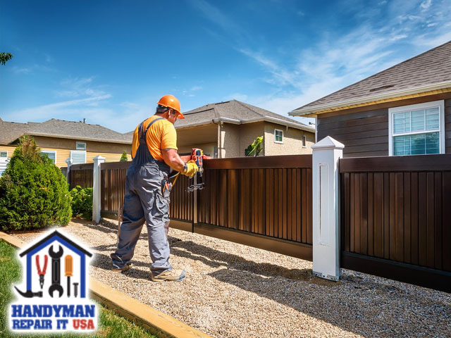 professional handyman working on professional gate and fence installations at residential home